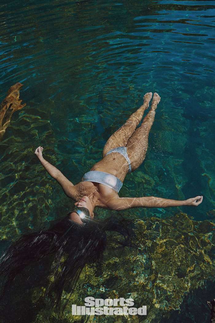 Kim Kardashian was photographed by Greg Swales in the Dominican Republic. Swimsuit by SKIMS. Sunglasses by Balenciaga.